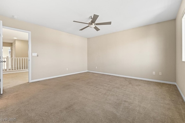 carpeted empty room featuring a ceiling fan and baseboards