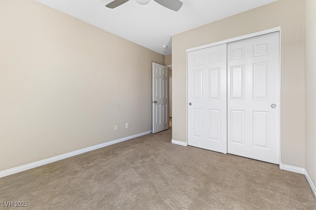 unfurnished bedroom with carpet floors, ceiling fan, baseboards, and a closet