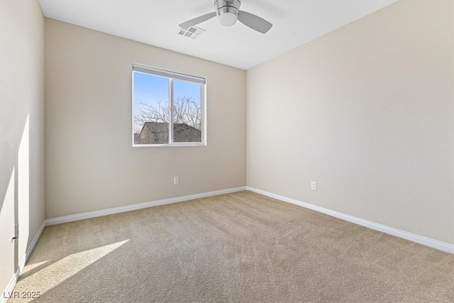 carpeted empty room with ceiling fan, visible vents, and baseboards