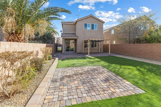 back of property with a tile roof, a fenced backyard, a yard, a patio area, and stucco siding