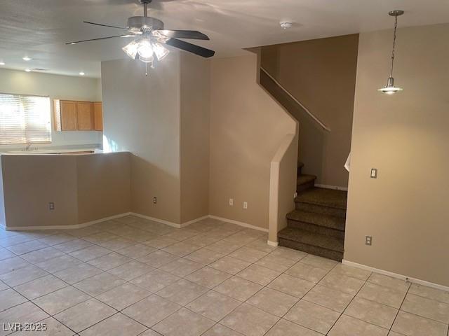 interior space featuring light tile patterned floors and ceiling fan