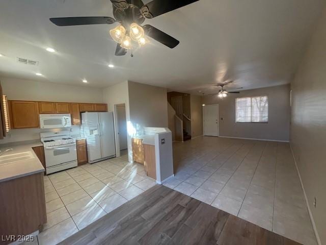 kitchen with light tile patterned flooring and white appliances