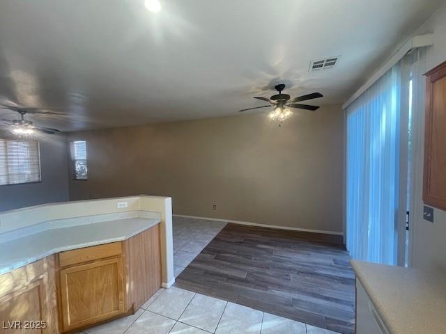 kitchen with ceiling fan and light tile patterned floors