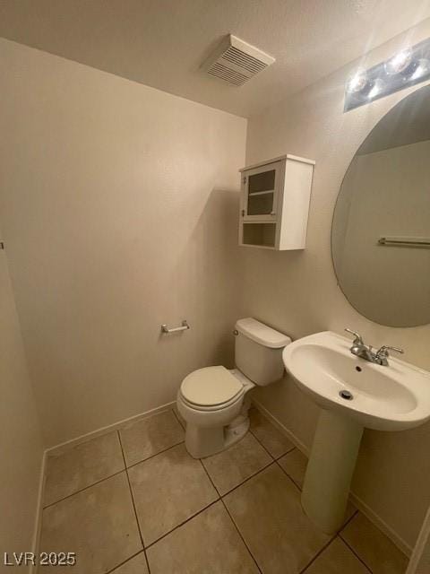 bathroom featuring tile patterned flooring, sink, and toilet