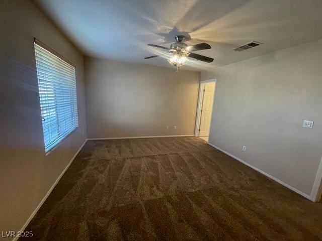 carpeted spare room with ceiling fan