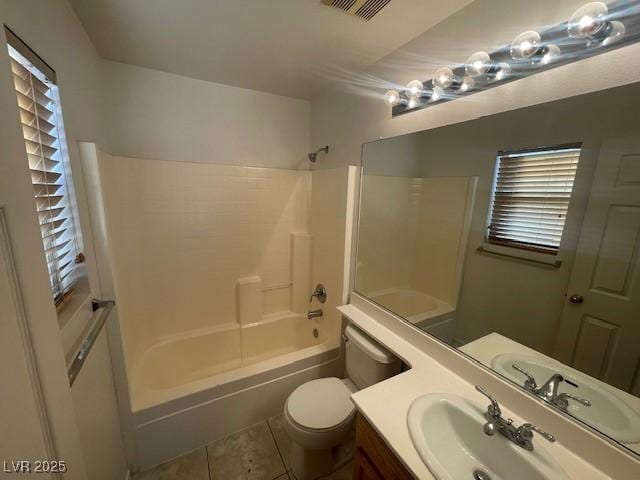 full bathroom featuring shower / tub combination, vanity, tile patterned floors, and toilet