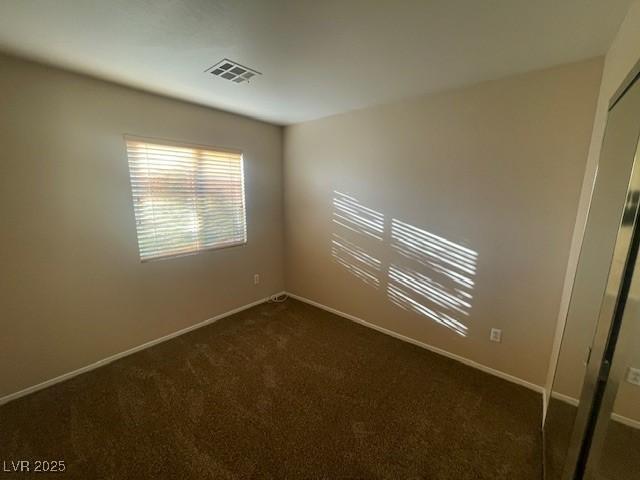 empty room with dark carpet