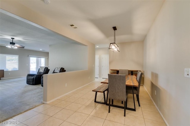 tiled dining room featuring ceiling fan