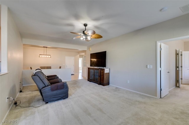 living area with ceiling fan and light colored carpet