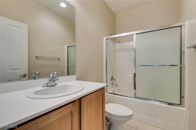 full bathroom featuring vanity, tile patterned flooring, bath / shower combo with glass door, and toilet