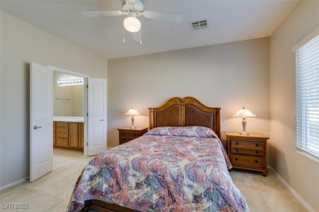 carpeted bedroom with ceiling fan and ensuite bathroom