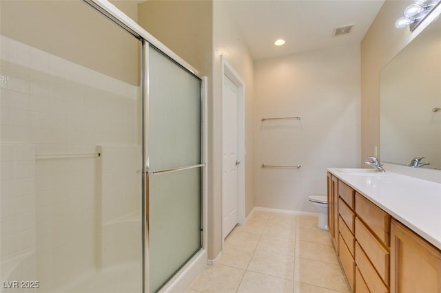 bathroom featuring walk in shower, vanity, toilet, and tile patterned flooring