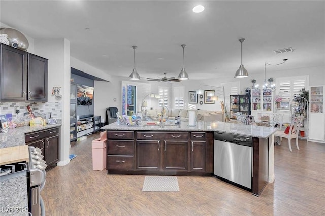 kitchen featuring dark brown cabinetry, appliances with stainless steel finishes, pendant lighting, and light stone counters