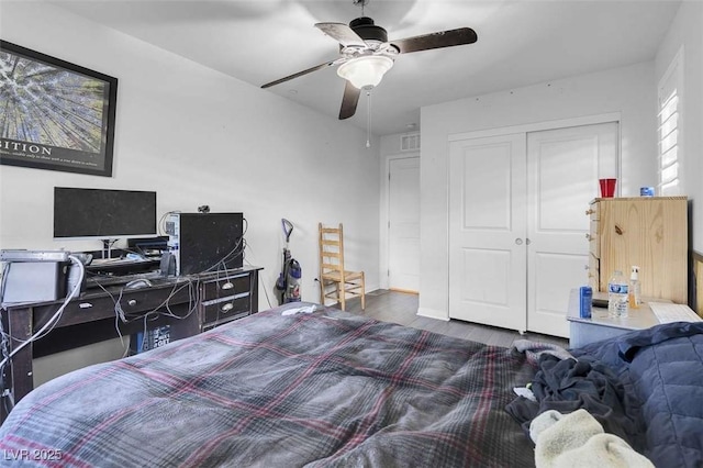 bedroom featuring ceiling fan, dark hardwood / wood-style flooring, and a closet