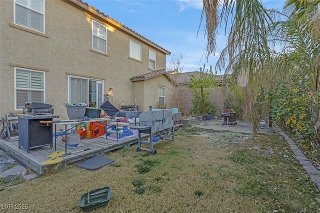 exterior space featuring a deck and a lawn