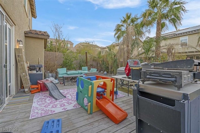 deck featuring an outdoor living space and a grill