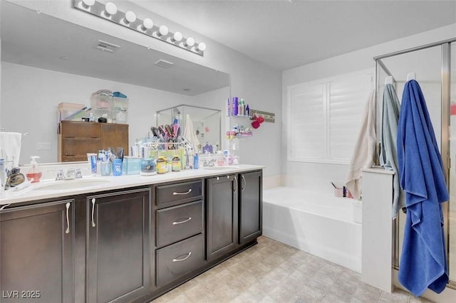 bathroom with vanity and independent shower and bath