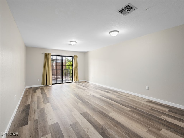 empty room with wood-type flooring