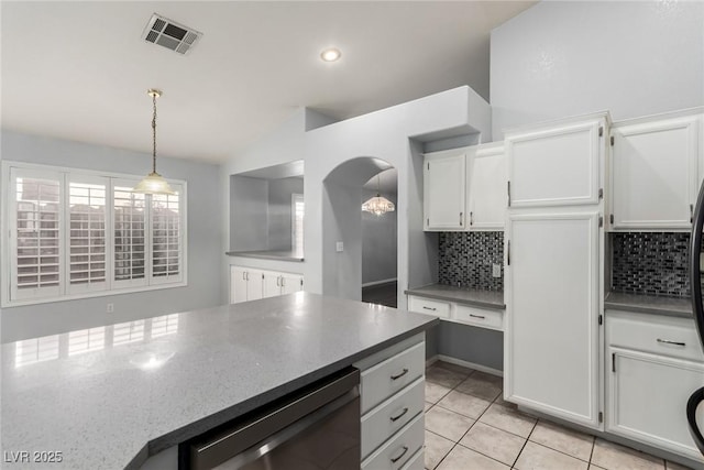 kitchen with white cabinetry, decorative light fixtures, light tile patterned floors, dishwasher, and backsplash