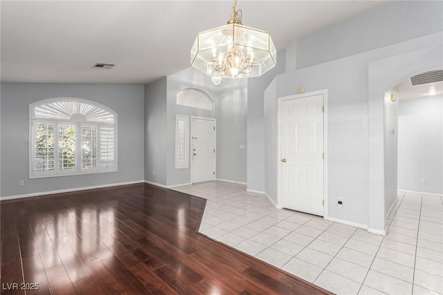 entryway with a notable chandelier and light hardwood / wood-style floors