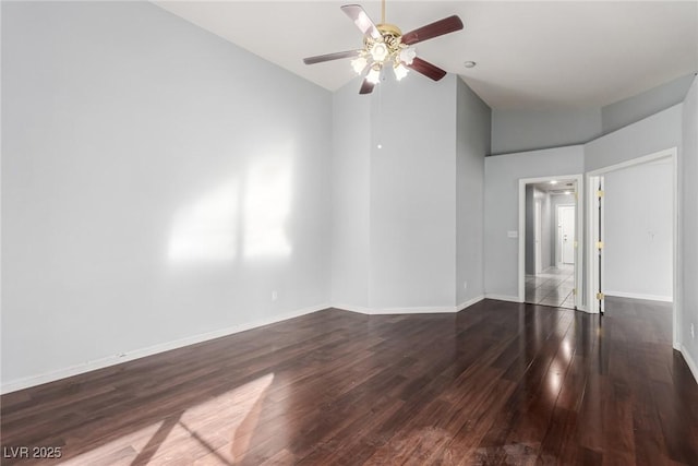 empty room featuring lofted ceiling, dark hardwood / wood-style floors, and ceiling fan