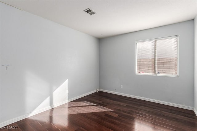 spare room with dark hardwood / wood-style floors