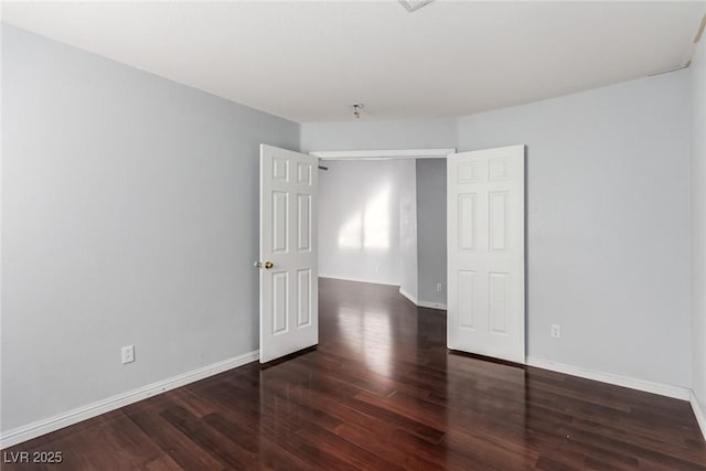 unfurnished bedroom featuring dark hardwood / wood-style flooring