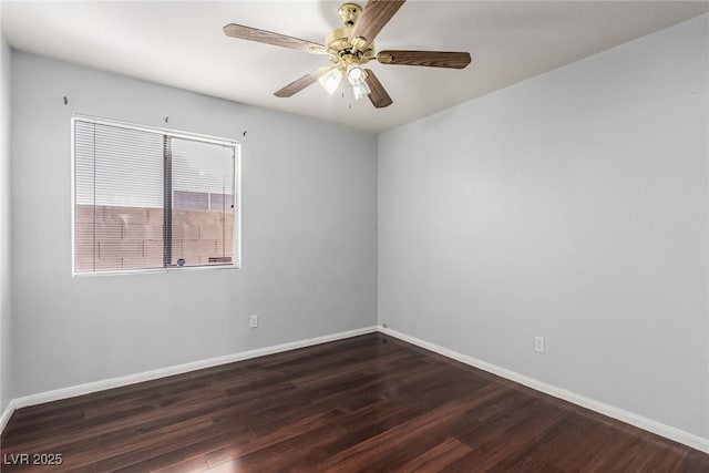 spare room featuring dark wood-type flooring and ceiling fan