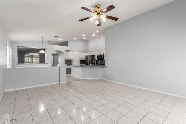 unfurnished living room featuring high vaulted ceiling, light tile patterned floors, and ceiling fan