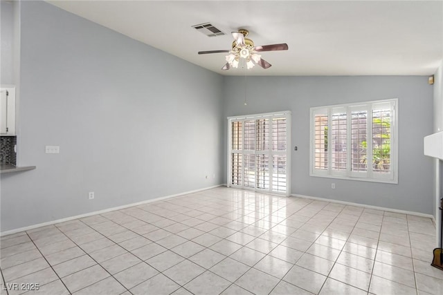 tiled spare room featuring lofted ceiling and ceiling fan