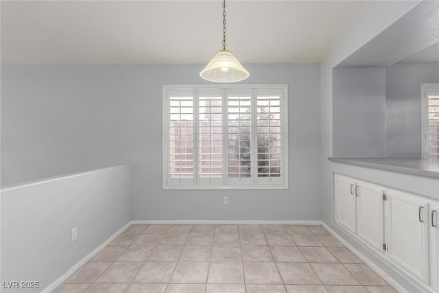 unfurnished dining area featuring light tile patterned floors