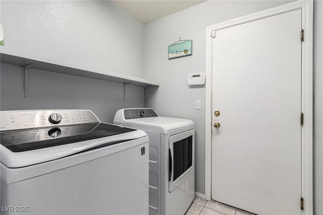 washroom featuring light tile patterned floors and independent washer and dryer