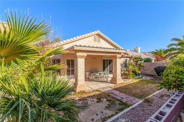 rear view of property featuring a patio area