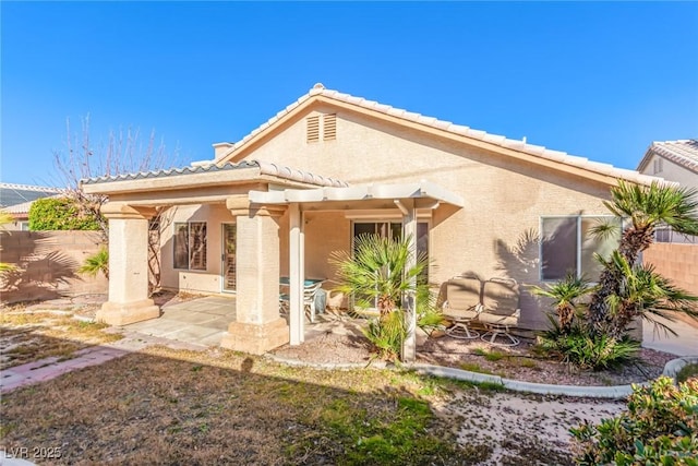 back of property with a patio