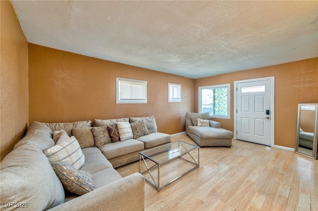 living room with light hardwood / wood-style flooring and a textured ceiling