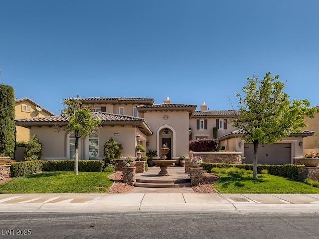 mediterranean / spanish house featuring a front yard