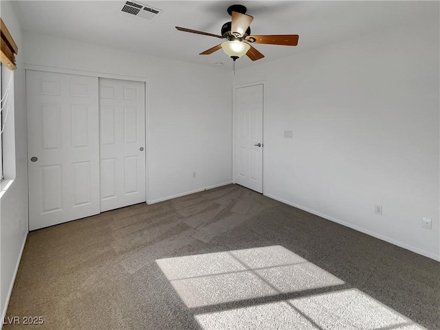 unfurnished bedroom featuring a closet, ceiling fan, and carpet flooring