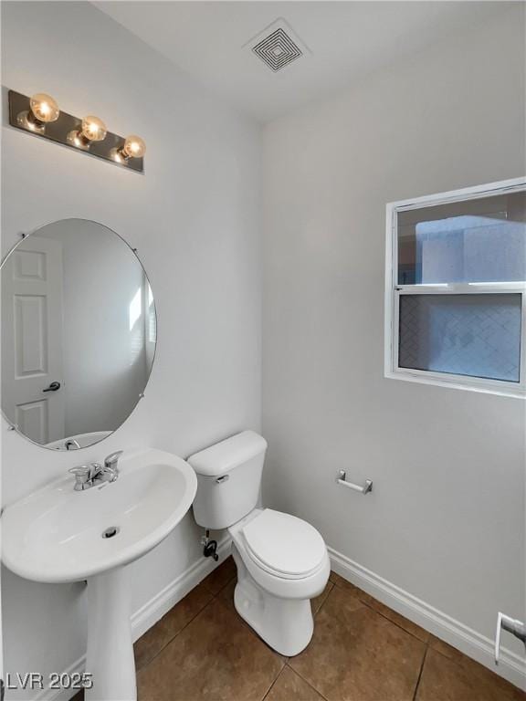 bathroom with tile patterned flooring and toilet