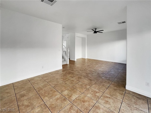 empty room featuring ceiling fan and light tile patterned floors