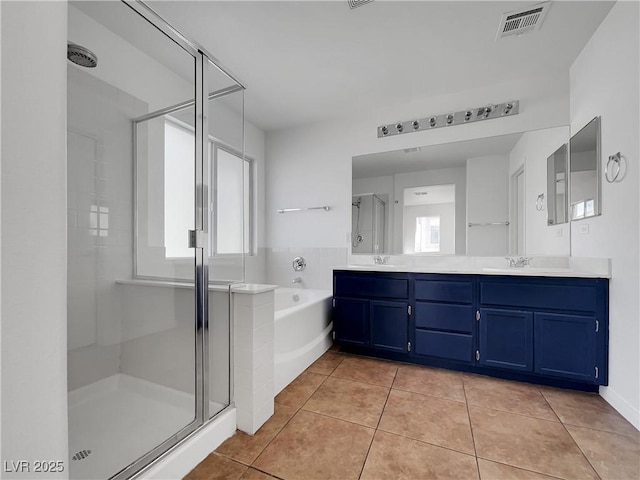 bathroom featuring vanity, shower with separate bathtub, and tile patterned floors