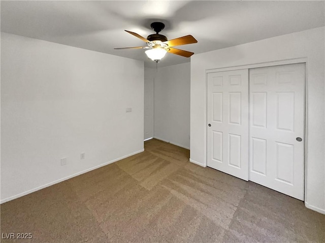 unfurnished bedroom featuring carpet, a closet, and ceiling fan