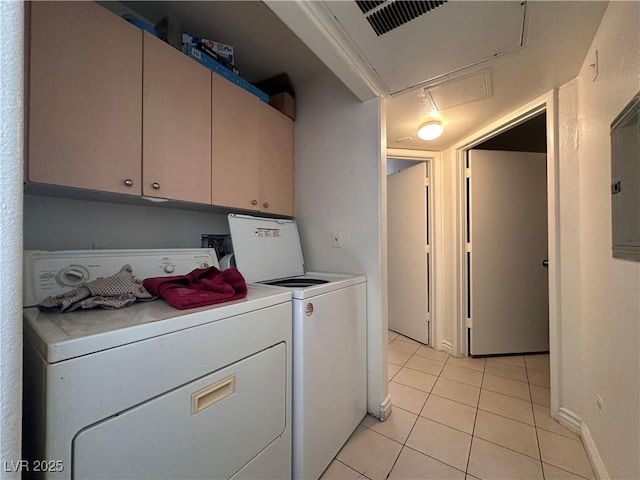 washroom with light tile patterned floors and washing machine and dryer