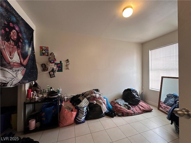 bedroom with light tile patterned floors