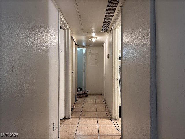 corridor featuring light tile patterned floors