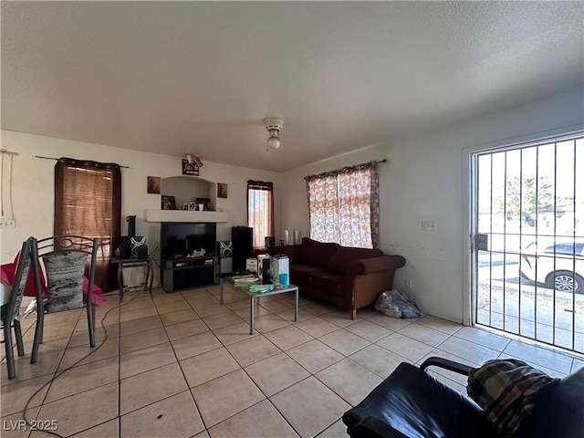 tiled living room featuring a healthy amount of sunlight