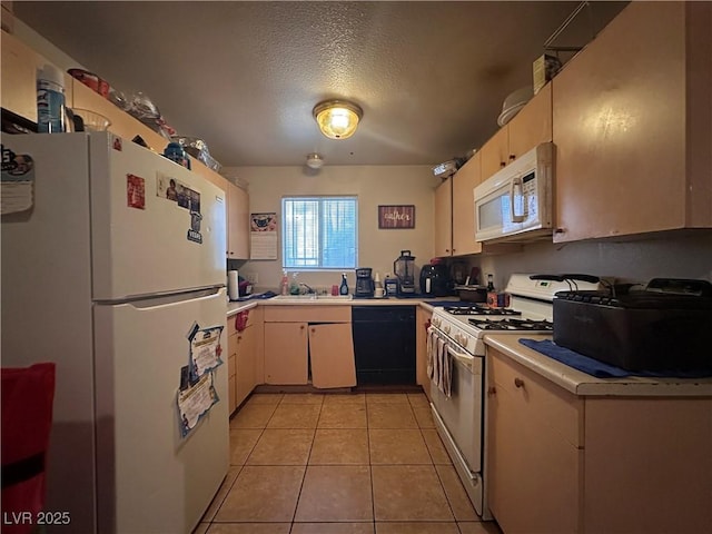 kitchen featuring light tile patterned floors, white appliances, sink, and a textured ceiling