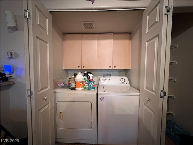 washroom with cabinets and independent washer and dryer