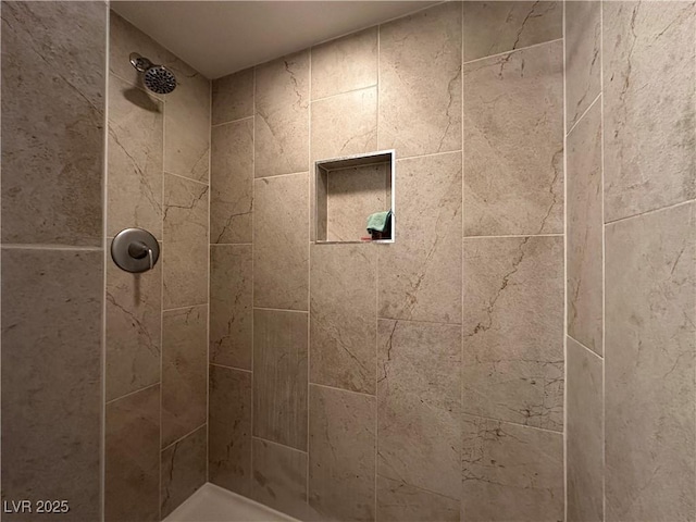 bathroom with tiled shower