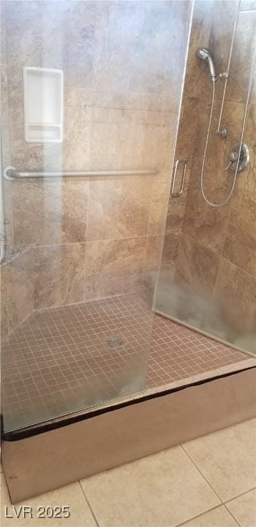 bathroom featuring tile patterned flooring and a shower with door