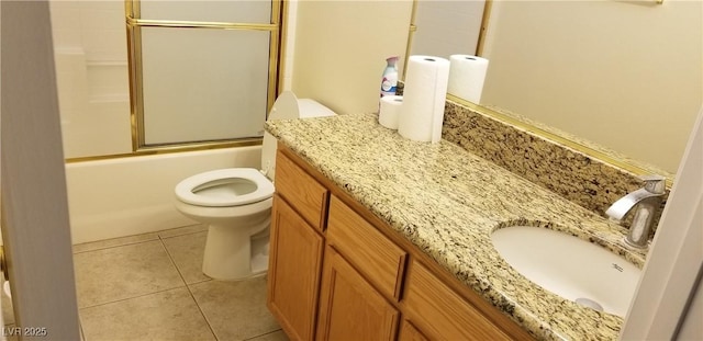 full bathroom with tile patterned flooring, vanity, shower / bath combination with glass door, and toilet